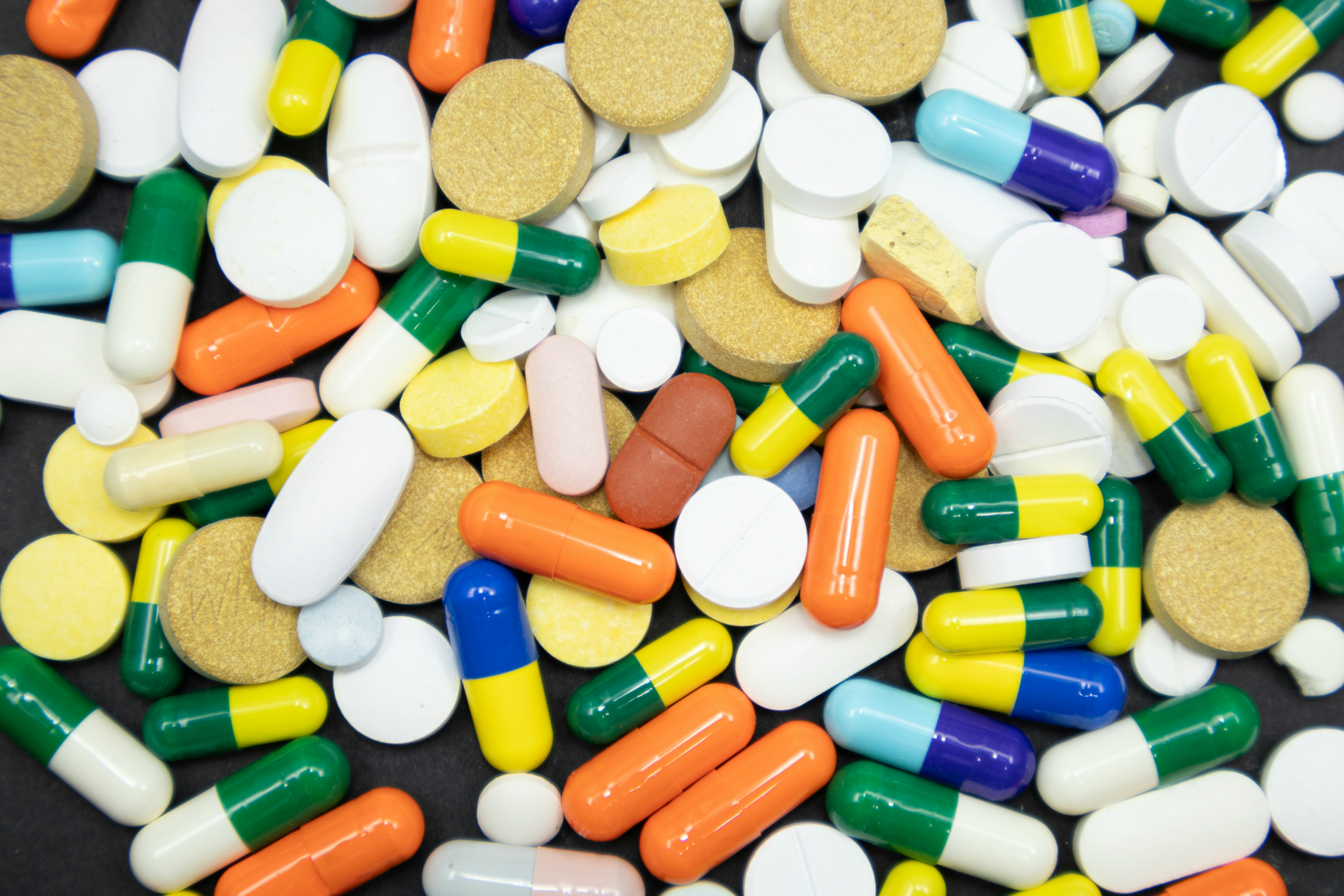 Assortment of colorful pills and capsules representing pharmaceutical predictive analytics